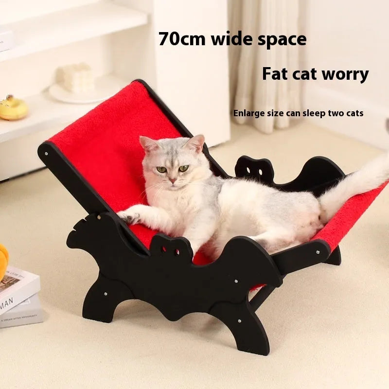 Wooden cat recliner bed with Halloween black and red design on raised platform