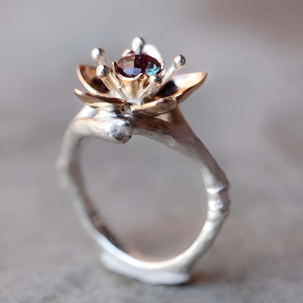 Silver two-tone women's ring with geometric floral design showing alloy construction and size options