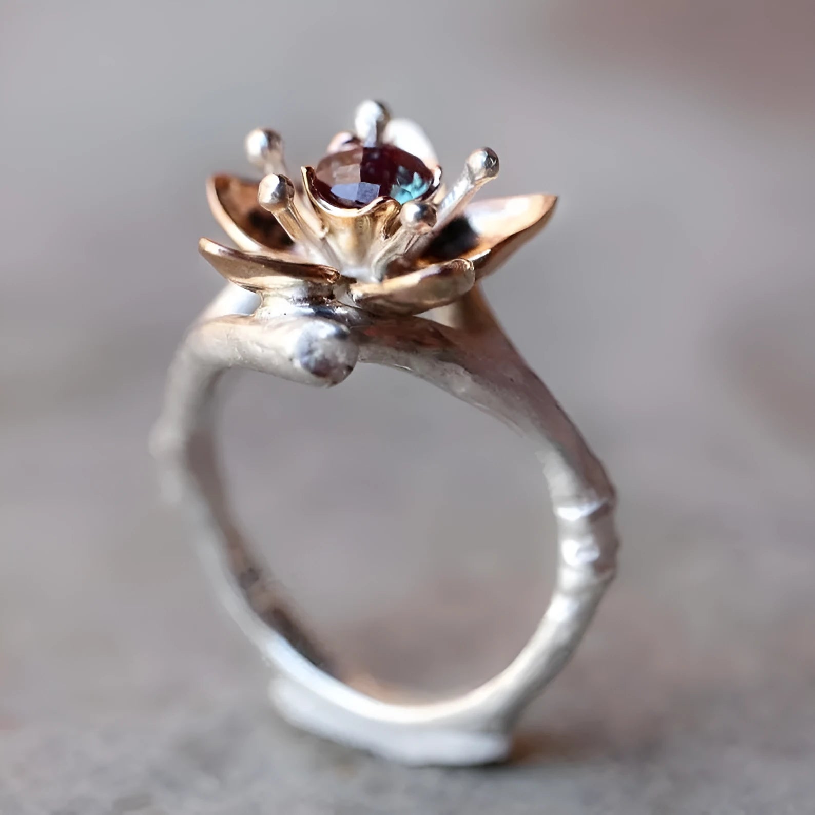 Silver two-tone women's ring with geometric floral design showing alloy construction and size options
