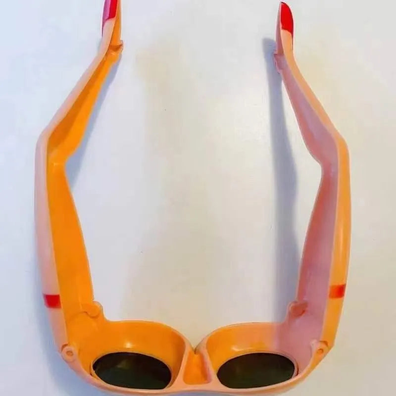 Orange plastic novelty sunglasses with a leg and hip design frame.