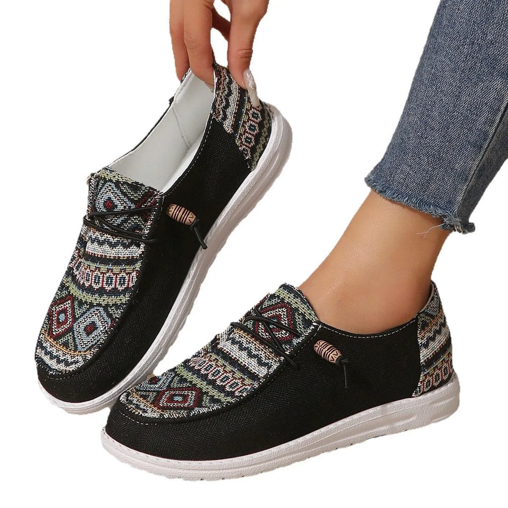 Women's black flat casual shoes with round toe and low-top design on a neutral background
