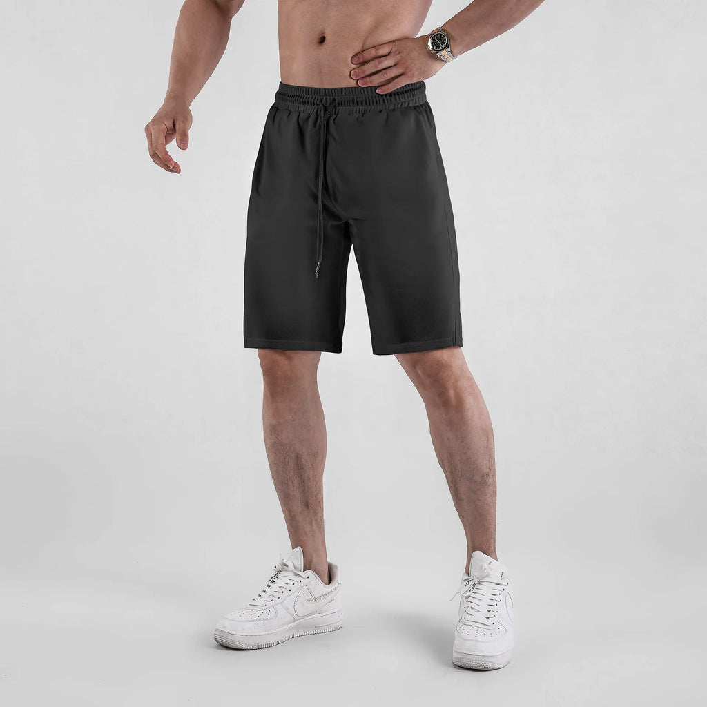Men's black quick-dry mesh fitness shorts with elastic waistband and loose fit
