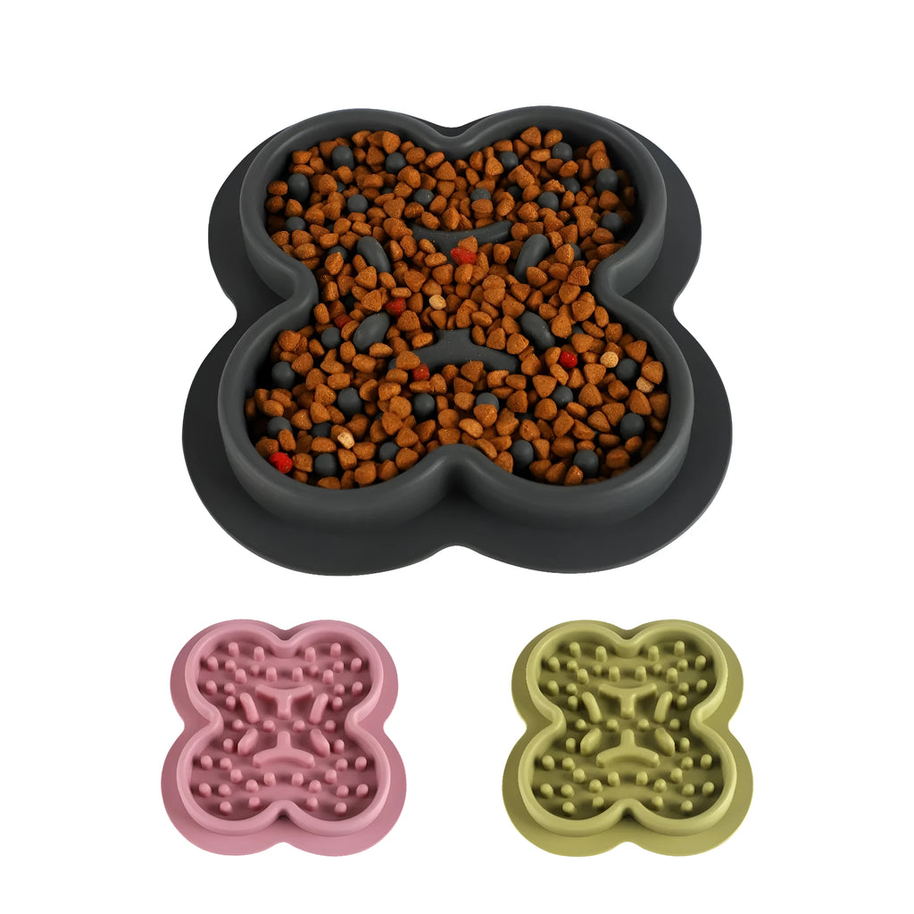 Silicone slow feeder licking pad for pets in various colours on a kitchen floor