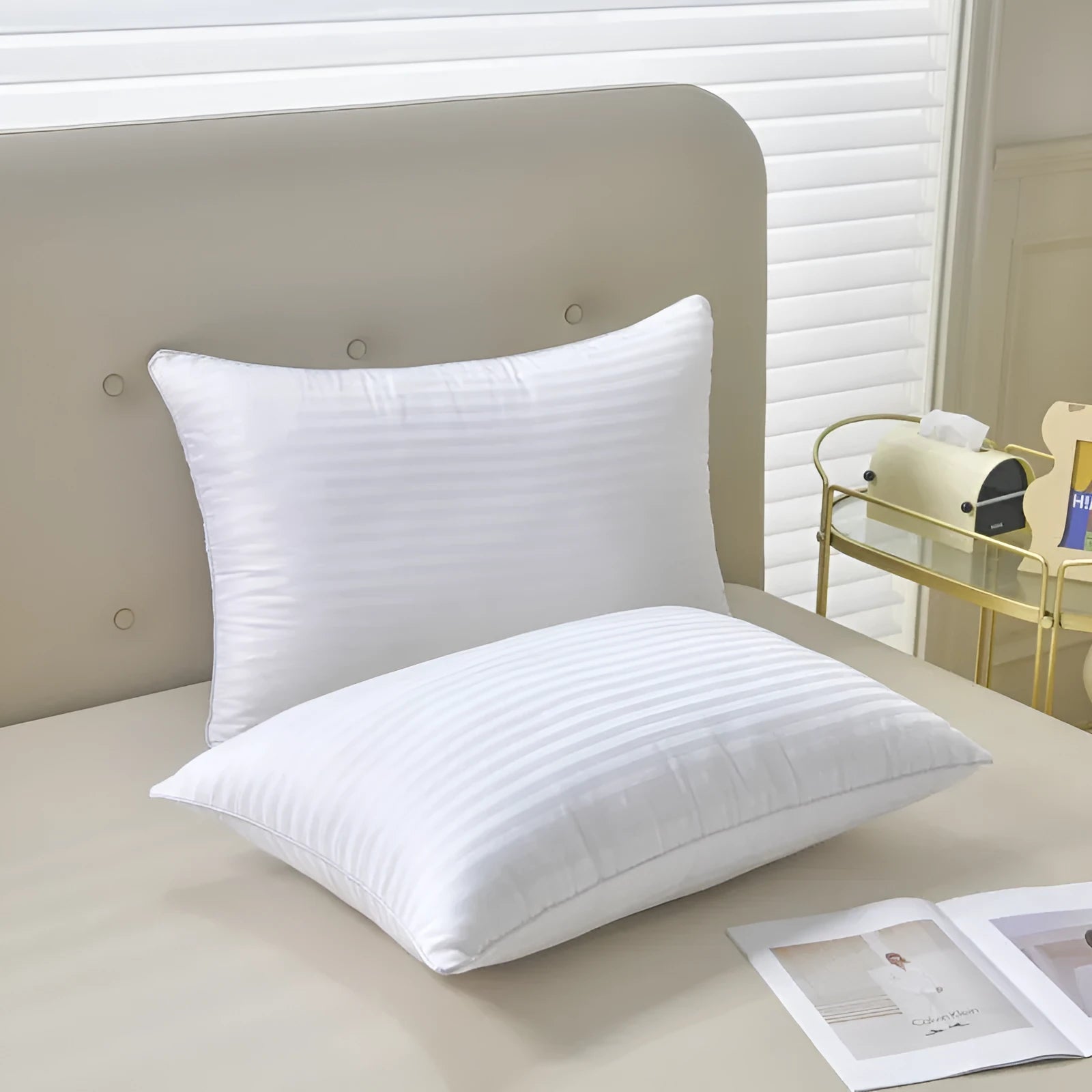 White cotton pillow with satin stripe pattern showing feather and cotton fill in three available sizes