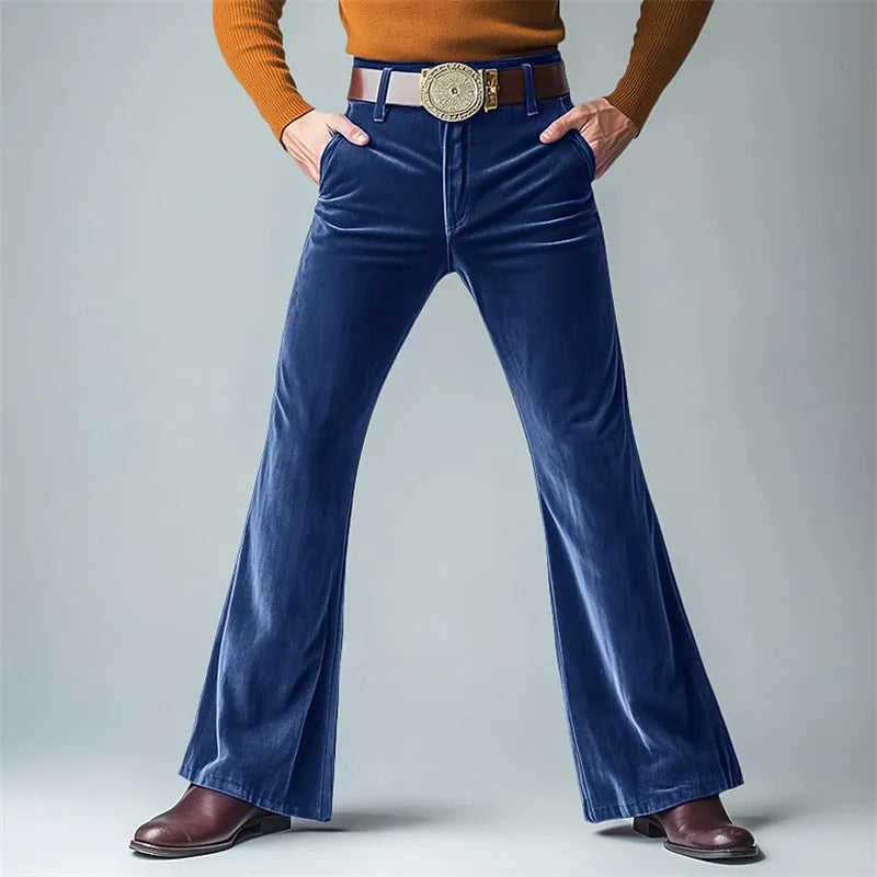 Man wearing slim flared velvet suit trousers in a dark colour for a banquet setting