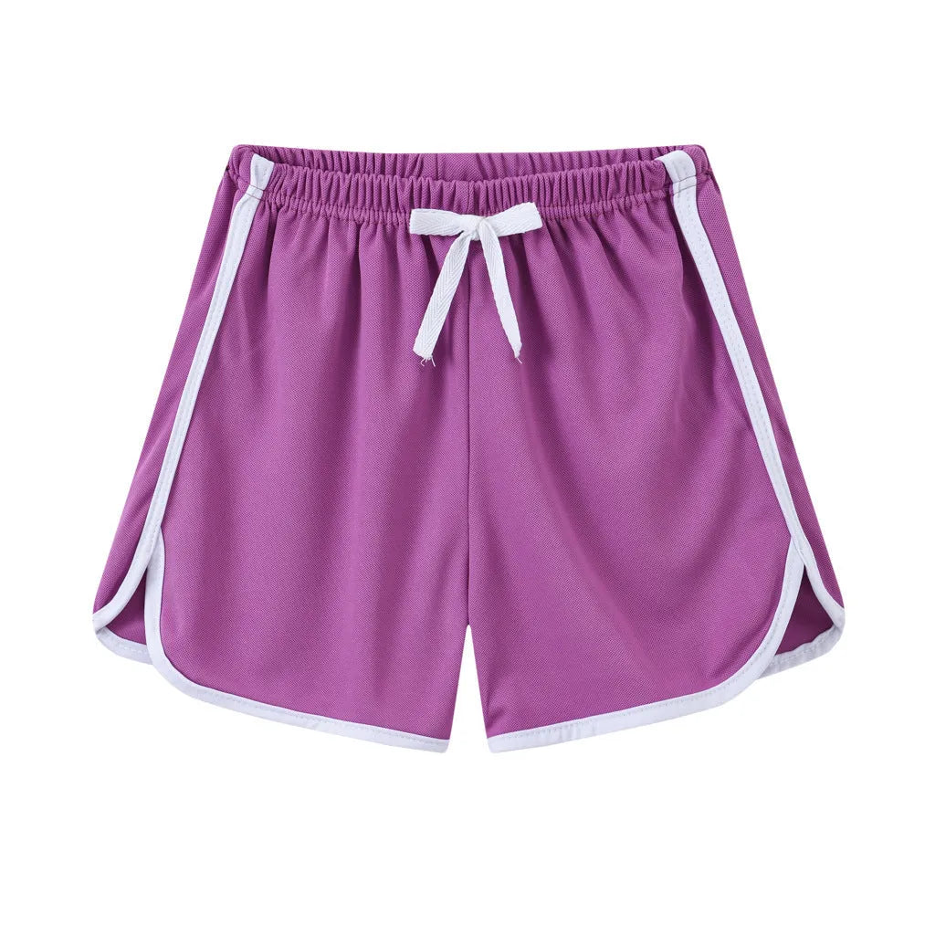 Children's colourful polyester beach shorts showing patterns like leopard print, stripes, and pineapples.