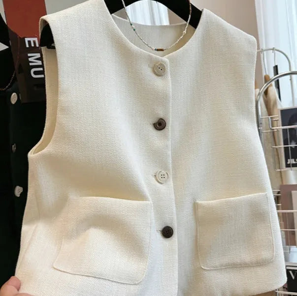 Sleeveless bandage dress vest with round neck in milky white or black polyester fabric.