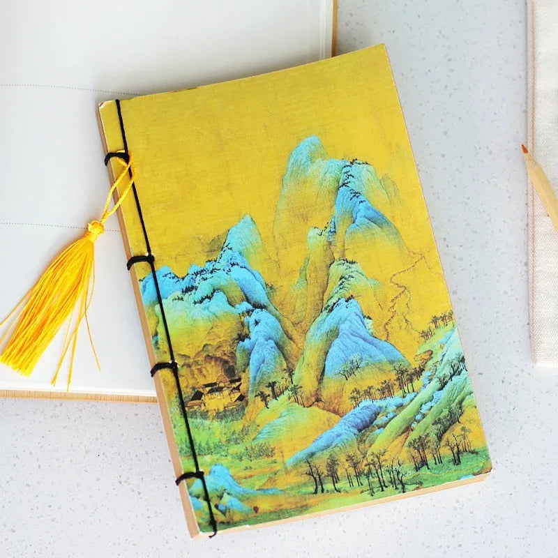 A5 antique wire-bound notebook with glossy embossed cover featuring a retro painting design, shown open.