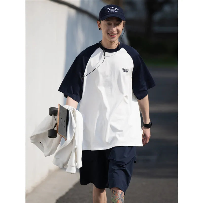Men's blue loose-fit casual t-shirt with raglan sleeves on a hanger.