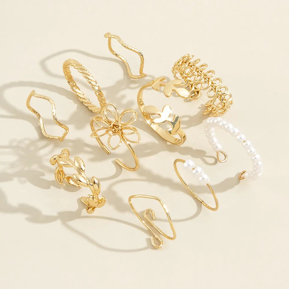 Gold-coloured alloy ring with openwork flower design and glossy electroplated finish