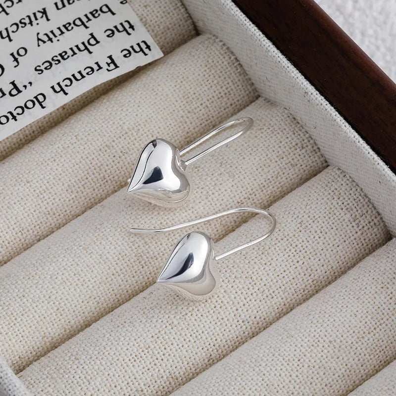 Silver heart-shaped copper earrings with three-dimensional glossy finish and Korean-style design