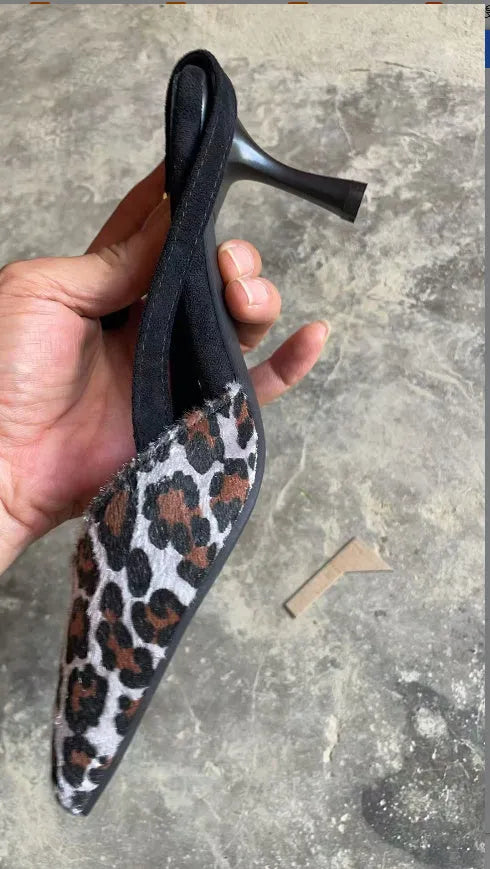 Leopard print suede women's sandals with a pointed toe and high heel.