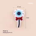 Small plush cat teaser toy in candy, eyes, and skull designs on a blue background.