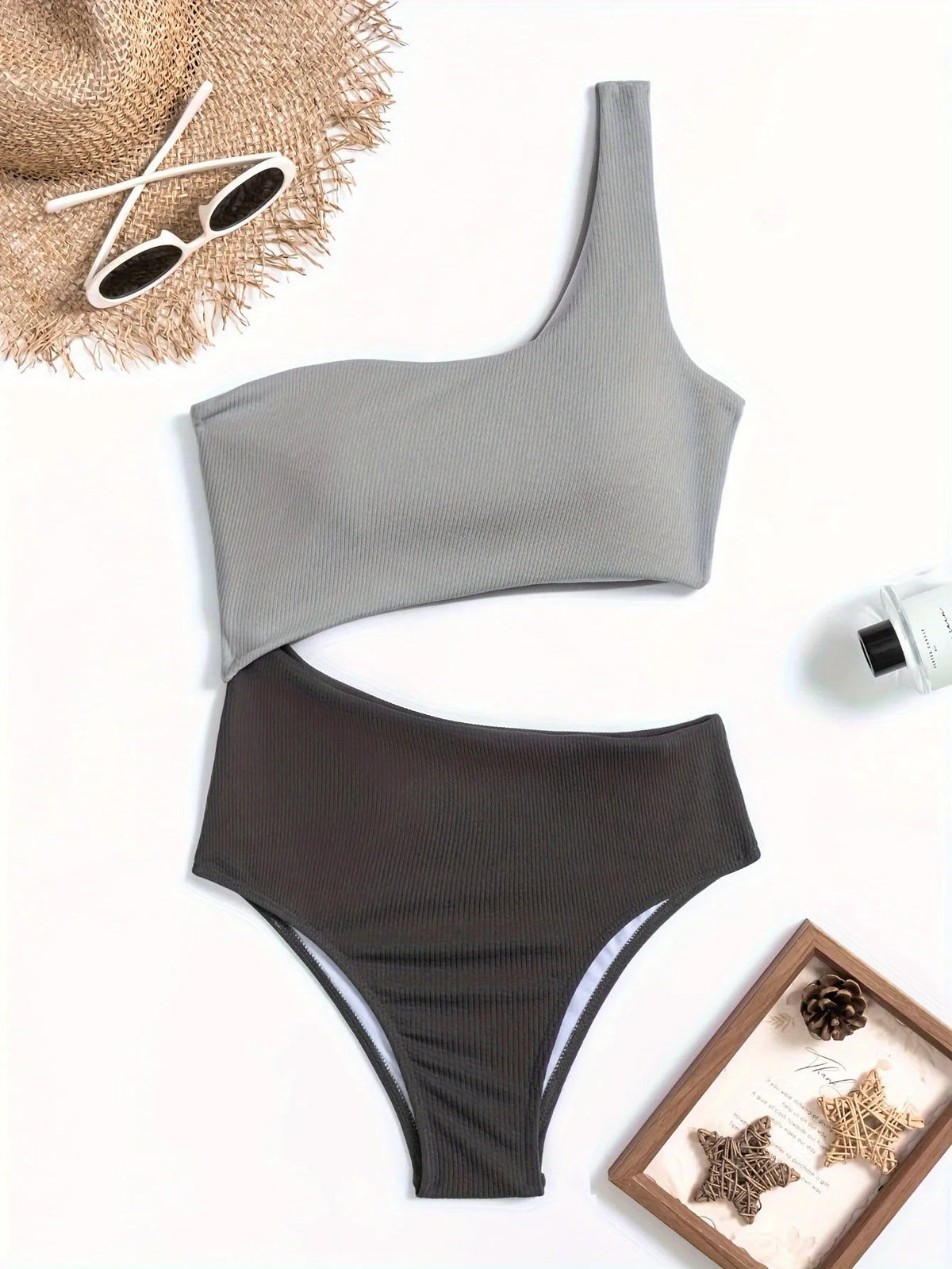 Women's light grey one-shoulder one-piece swimsuit on a white background