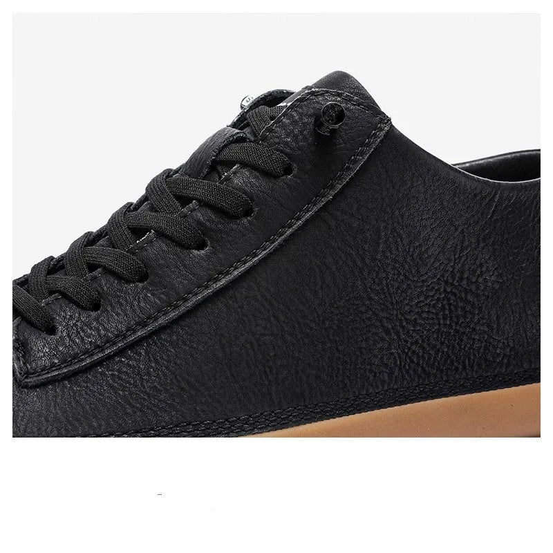 Men's black leather casual shoes with round toe, flat heel, and white rubber sole on a plain background.