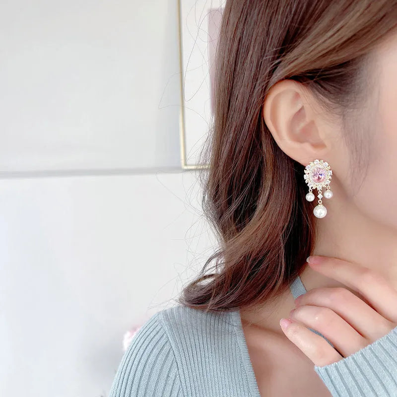 Oval geometric earrings with zircon inlay and tassel detailing in light purple, pink, and white colour options