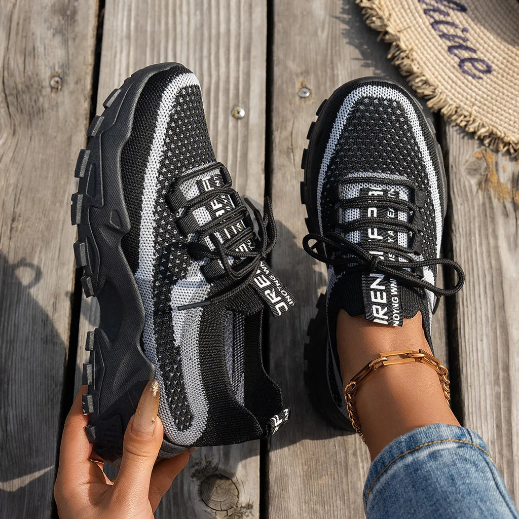 Women's flyknit mesh sneakers with rubber sole and lace-up design in black and gray