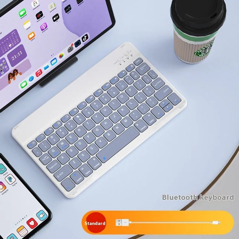 Girls Bluetooth tablet keyboard in multiple colour options including white, green, and pink on a desk