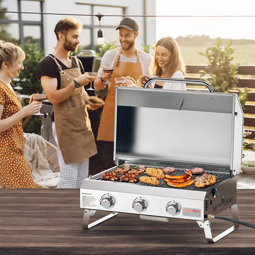 Silver desktop gas barbecue grill with three burners and foldable legs