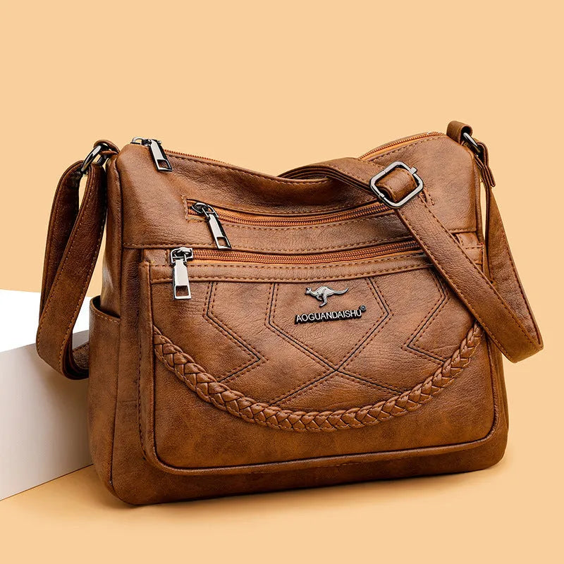 Soft PU leather crossbody shoulder bag in a horizontal square shape, shown in one of four colours: black, blue, red, or yellow.