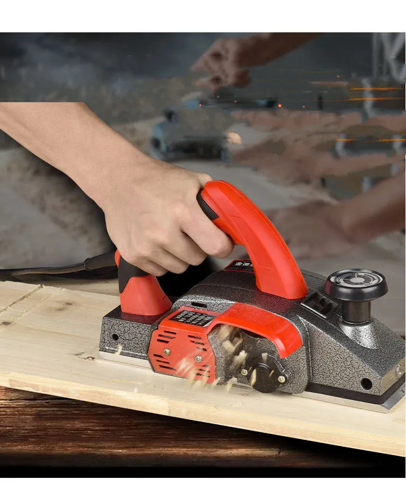 Red aluminium electric wood planer tool with 82mm cutting width on workbench