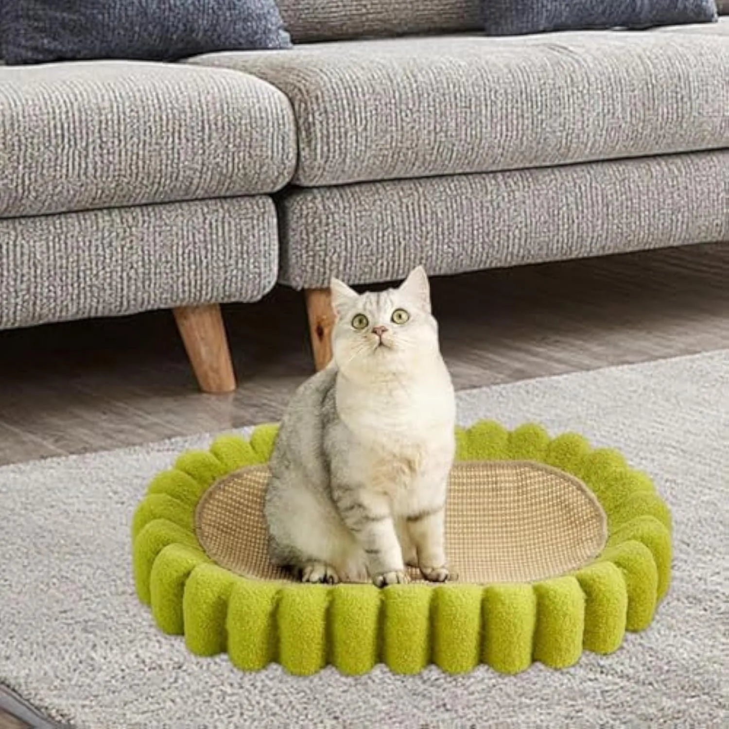 Green oval sisal cat scratching pad and lounge bed measuring 65cm long.