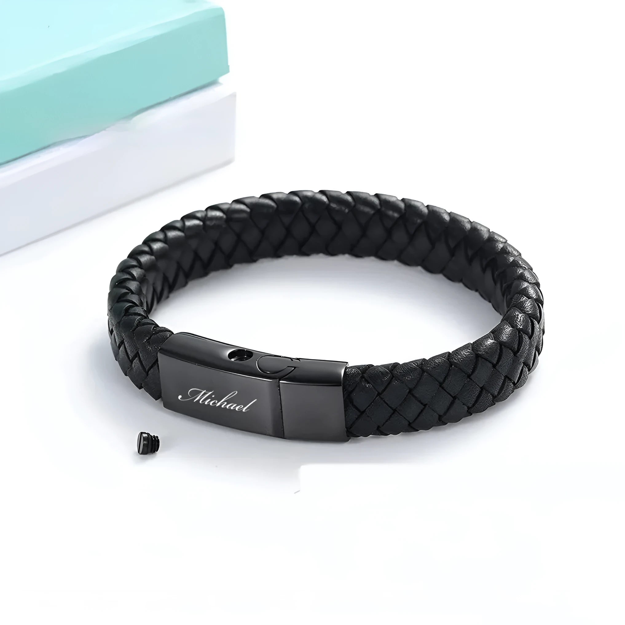 Black stainless steel bracelet with leather cinerary charm and engraved text, presented in a gift box.