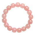 Natural pink crystal bracelet with barrel-shaped geometry beads measuring 8 x 10mm