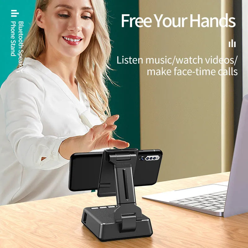 Black mobile phone stand with integrated Bluetooth speaker and microphone on a desk