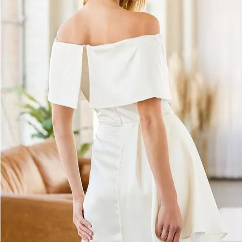 A woman wearing an off-shoulder strapless dress with short sleeves, a high waist, and a patchwork skirt.