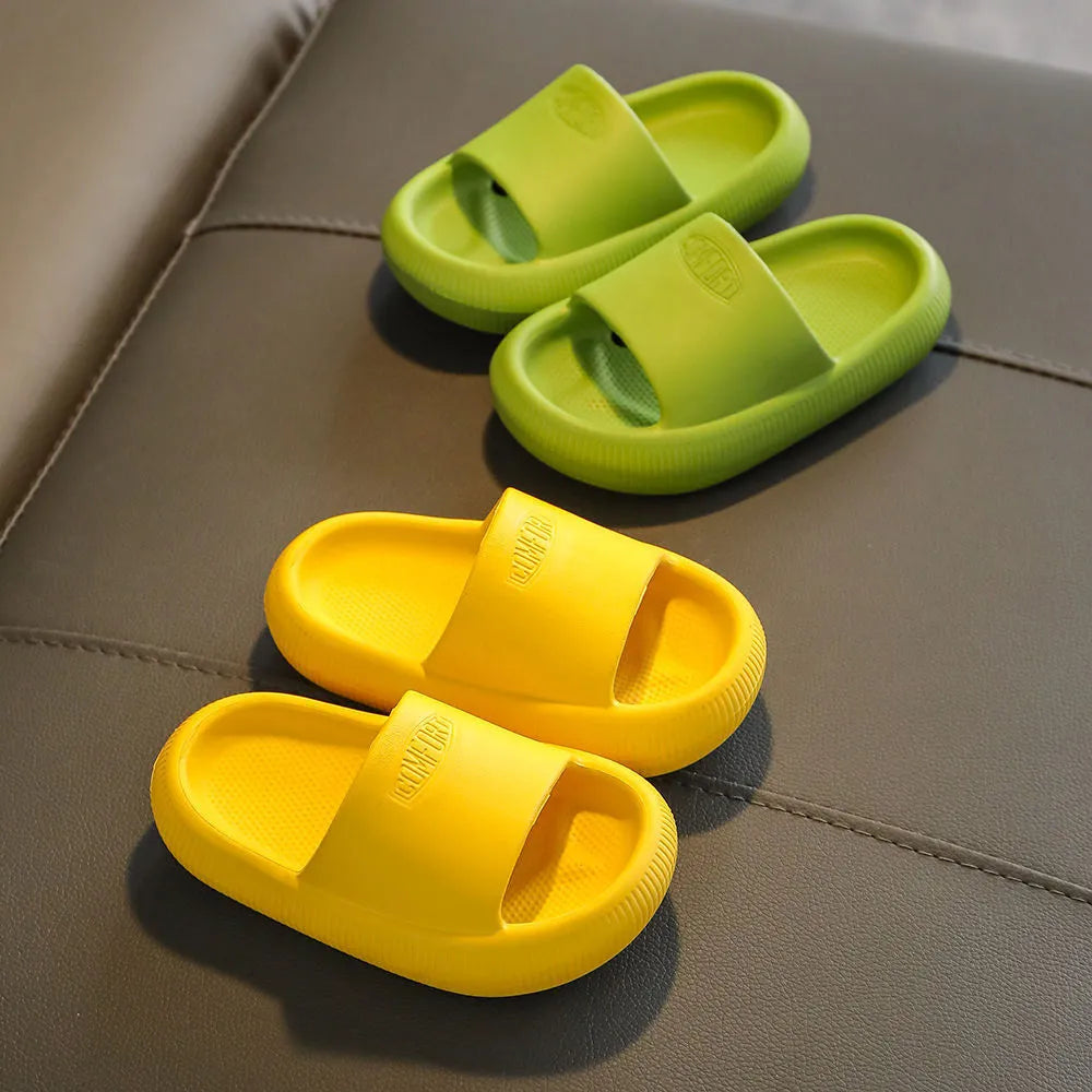 Children's bright coloured EVA slippers with textured non-slip soles, shown in blue, green, orange, pink, and yellow.