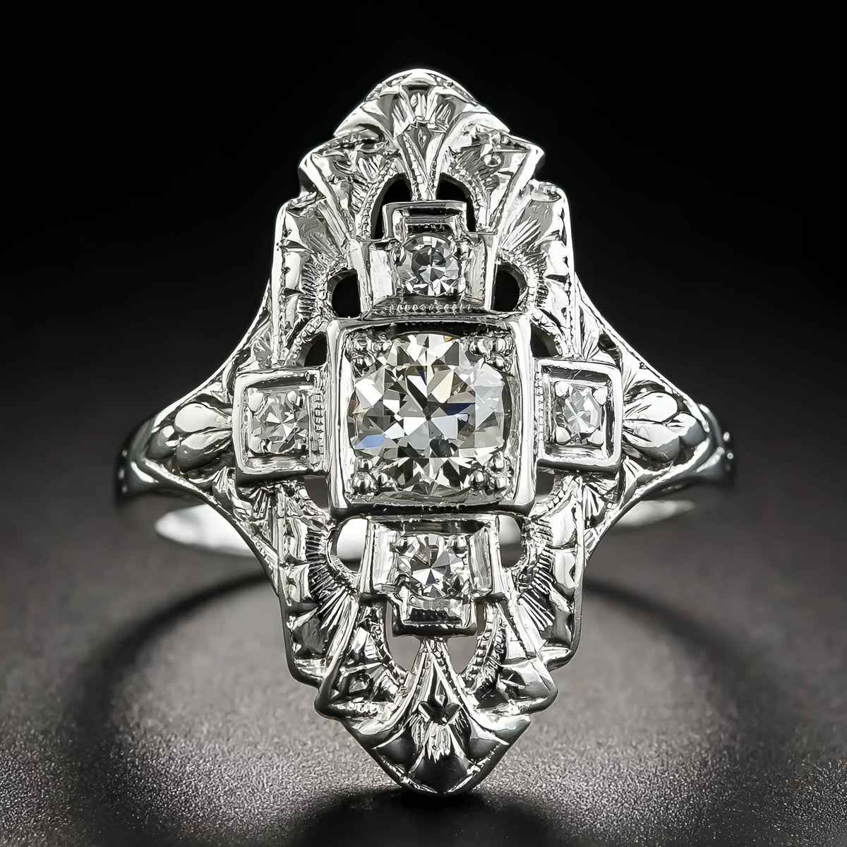 Hollow geometric silver-coloured ring with diamond-studded cubic zirconia stones, shown in profile view