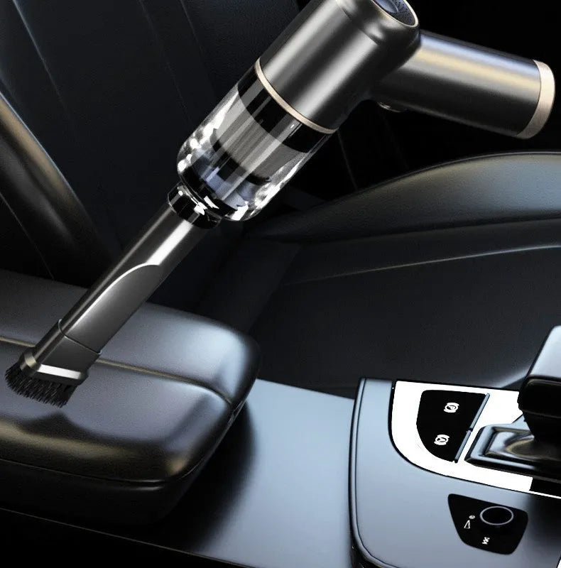 Black wireless car vacuum cleaner with multiple nozzle attachments and a USB charging cable on a car seat.