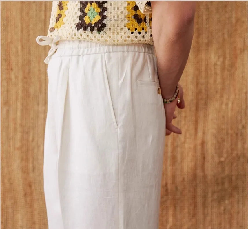 Women's loose fit high waist linen trousers in greige colour with straight leg and elasticated waistband.