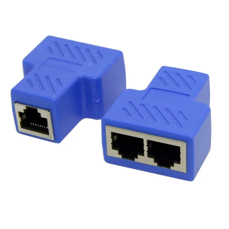 Two white RJ45 three-way network tee splitters on a table.
