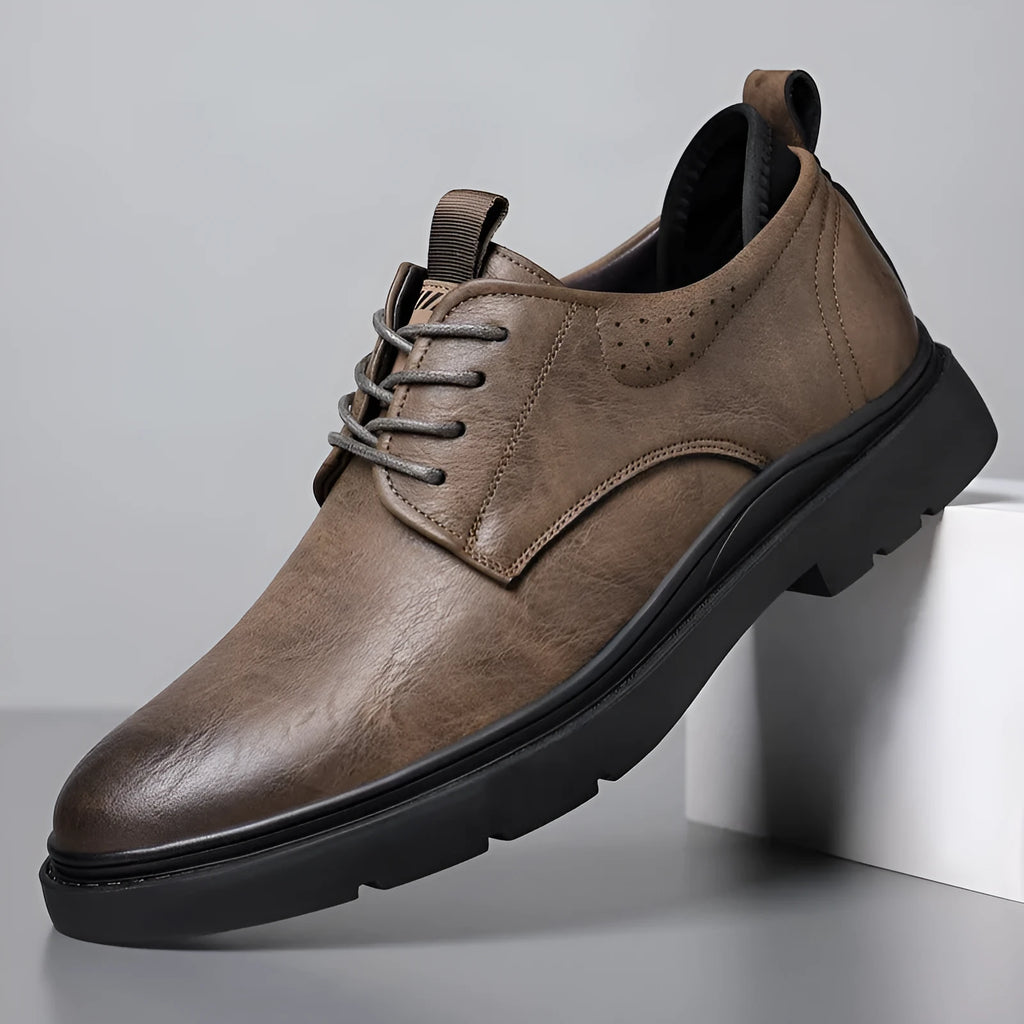 Men's black and brown breathable leather casual shoes with rubber sole and sewing line detail.