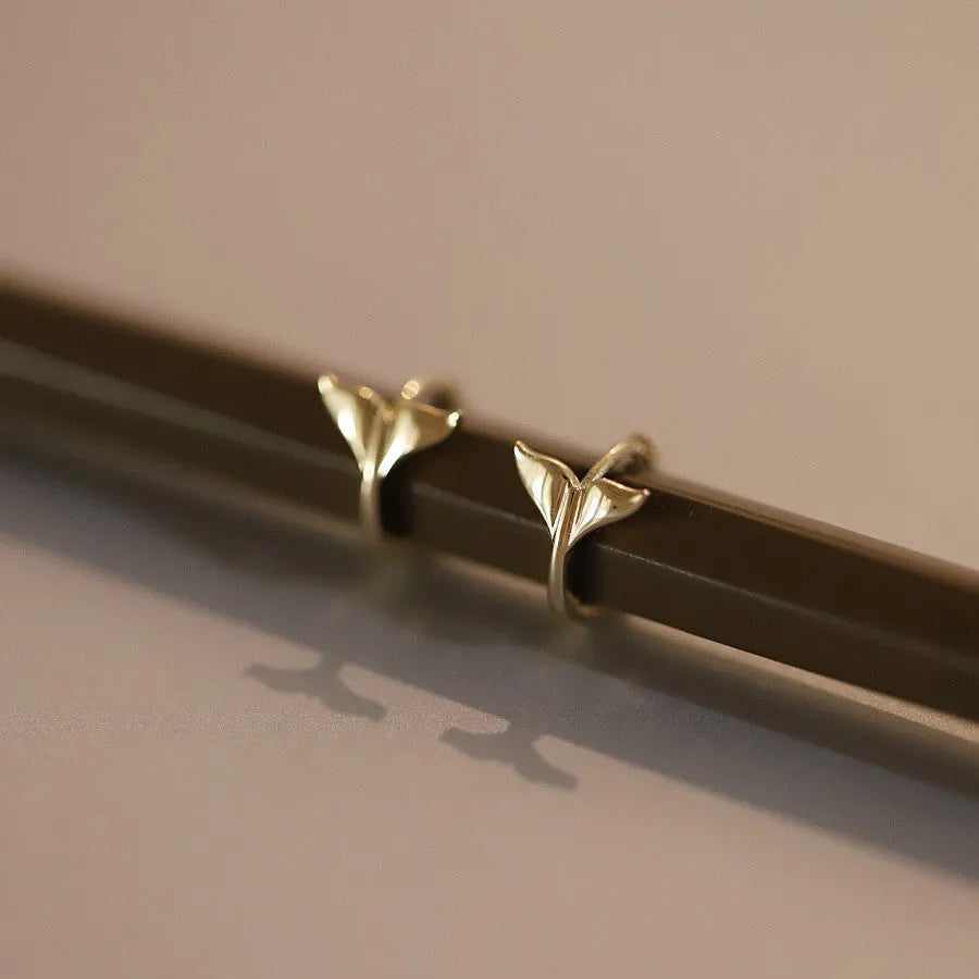 Pair of S925 sterling silver earrings with 14k gold plating featuring a smooth fishtail design and 8mm inner diameter