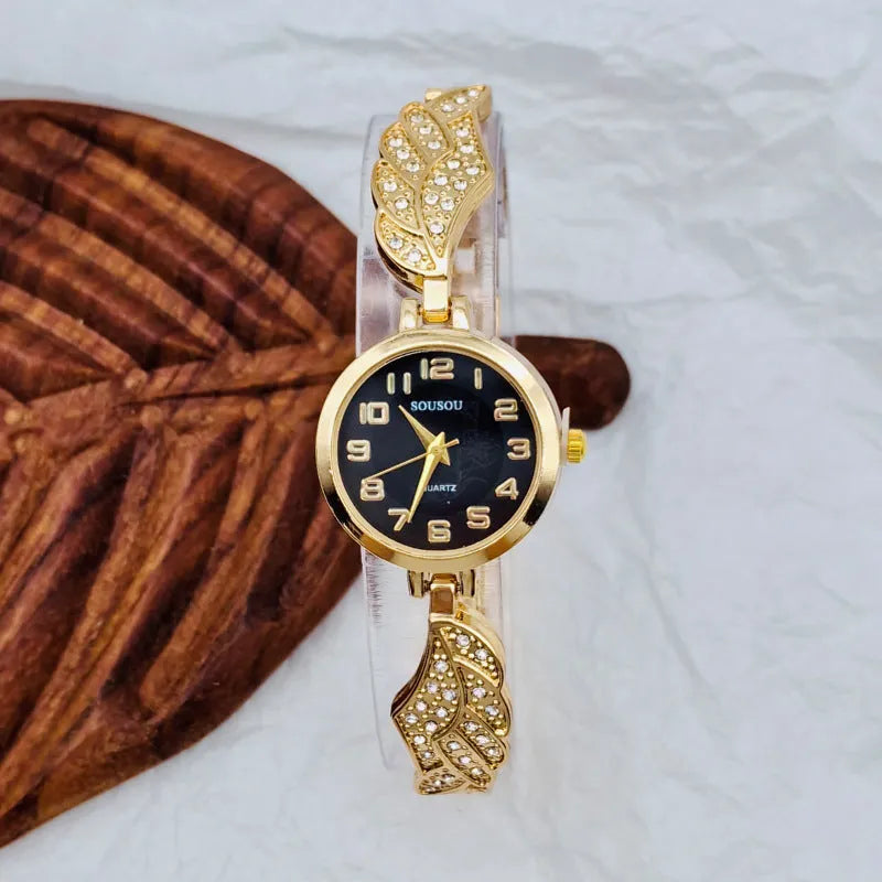 Stainless steel women's watch with round dial and Vachette clasp buckle on wrist.