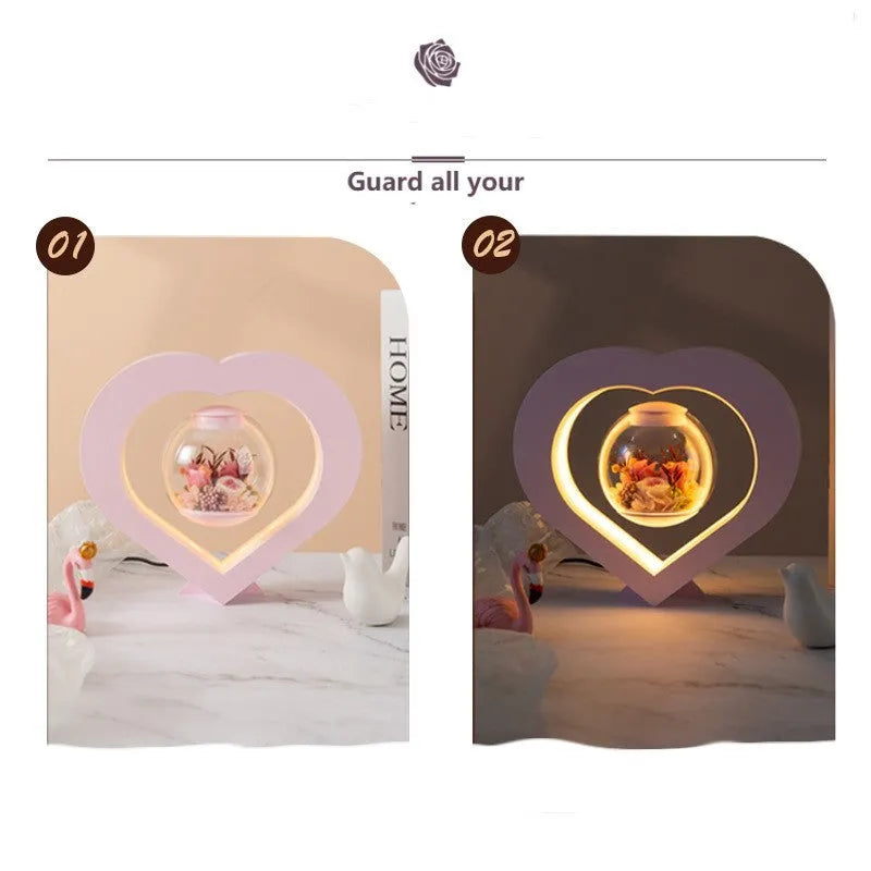 Pink preserved rose ornament with LED lights on a base with audio Bluetooth connectivity.