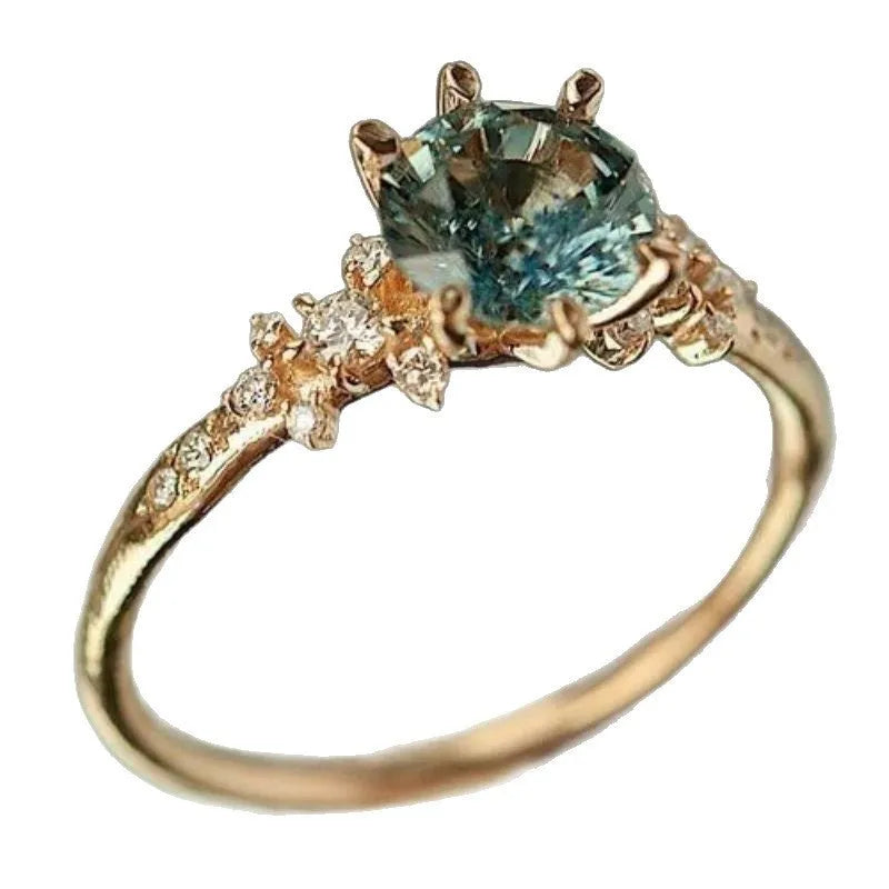 Gold geometric claw ring with micro-set zircon stones and a chamfered square pattern design.