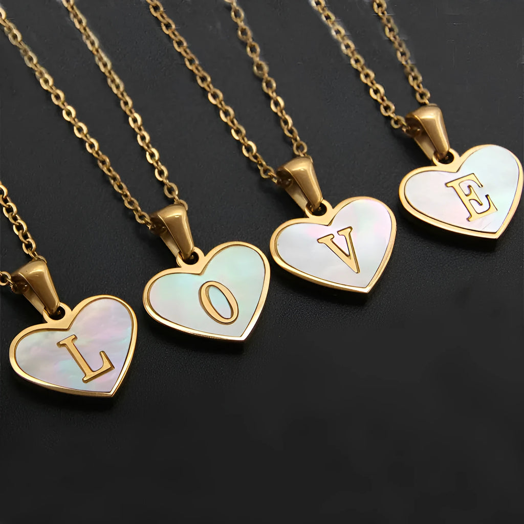 Gold-plated heart-shaped white shell pendant necklace on a stainless steel chain with extendable clasp
