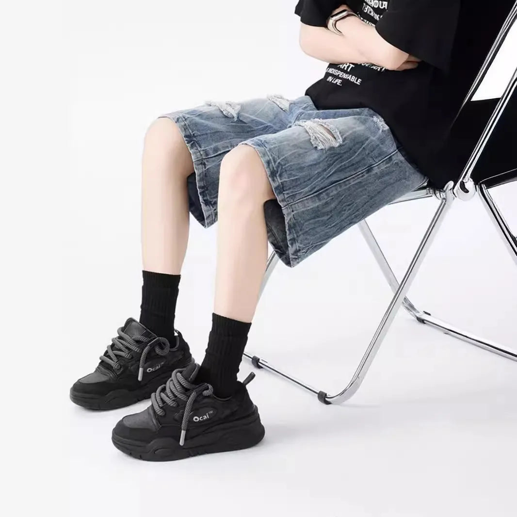 Retro loose fit denim shorts with washed and ripped detailing in blue and black colours