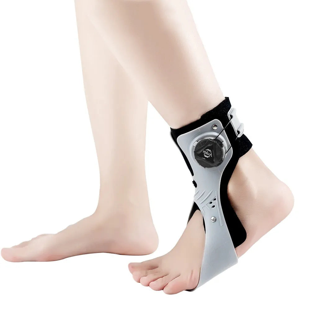 Grey adjustable ankle support brace with airbag button, shown on a left foot.