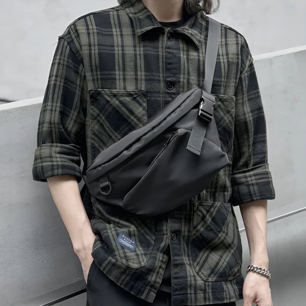 Black men's slanted chest bag made from Oxford fabric, showing sewing line details.
