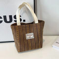 Japanese style corduroy shoulder bag in dark brown colour showing textured fabric and large main compartment