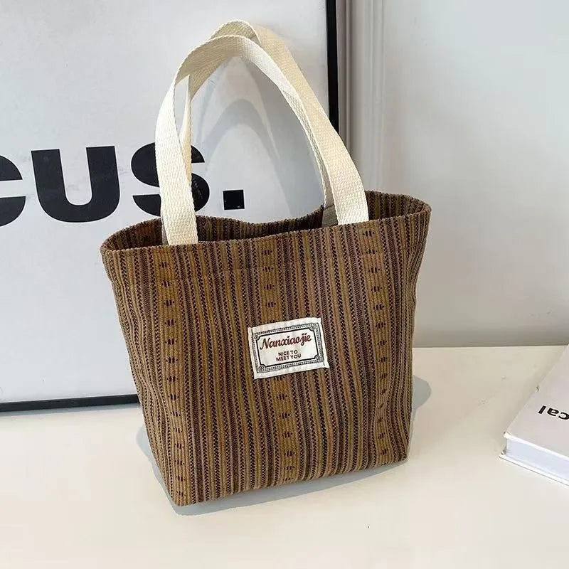 Japanese style corduroy shoulder bag in dark brown colour showing textured fabric and large main compartment