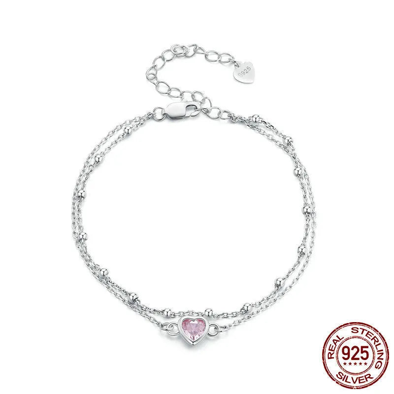 Women's 925 sterling silver bracelet with small heart-shaped pendant on an adjustable chain.