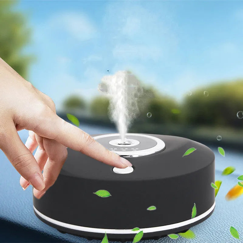 USB-powered black car air freshener diffuser with charging cable and anti-slip pad on a car dashboard.