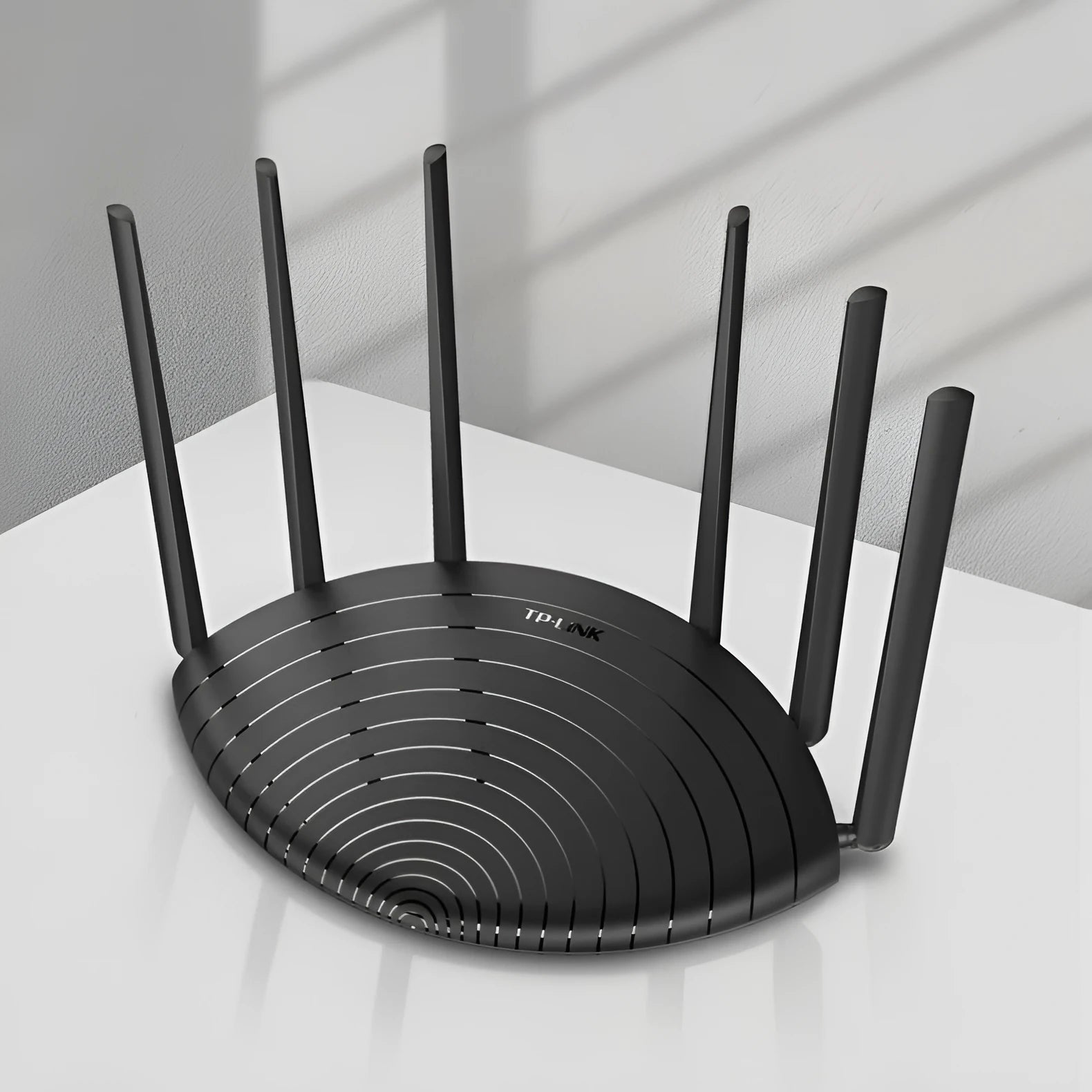 TL-WDR7661 AC1900 Gigabit wireless router shown in a home setting with network cable.