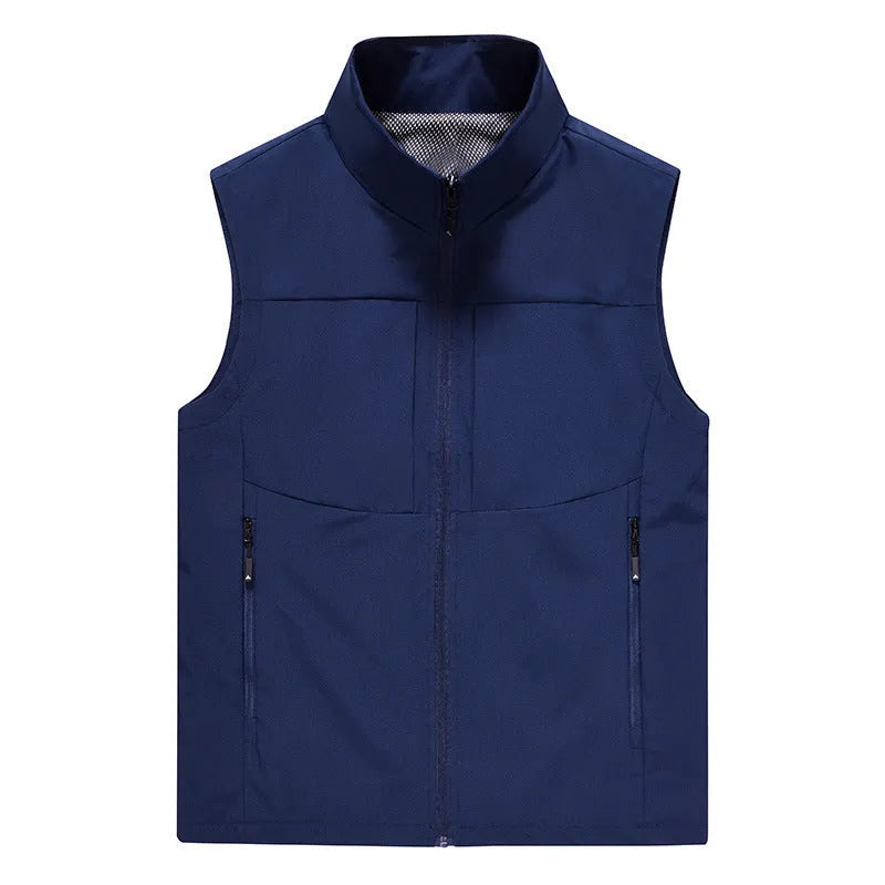 Man wearing a khaki stand collar cardigan vest with zipper pockets outdoors.